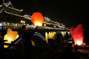 Ryan Boarman at the main Ya'an bridge releasing his lantern near the main bridge.