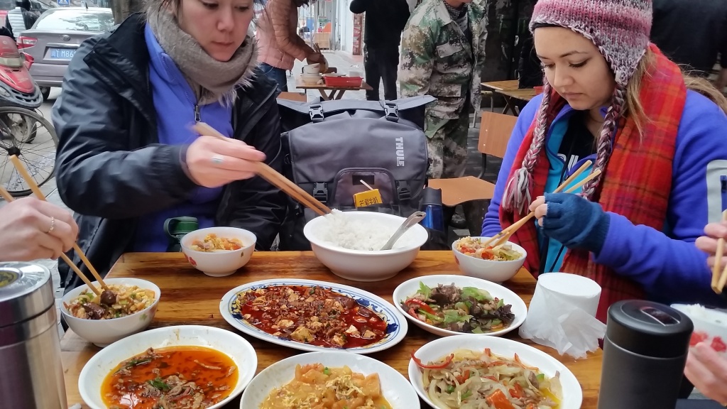 Alyssa and Ari enjoying a stir fry meal featuring some of our favorites; mápó dòufu, tomato egg, twice cooked pork, and a mushroom dish. 